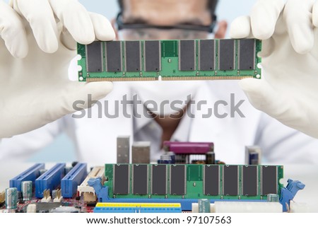 A scientist checking the memory card of motherboard