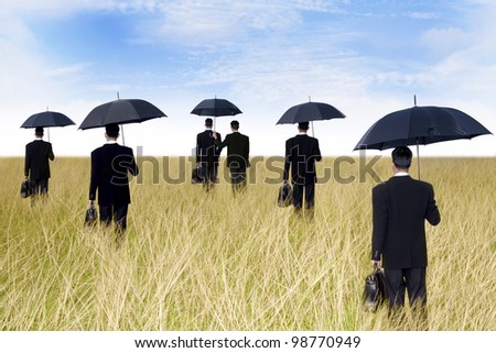 agent concept: businessmen with umbrella ready to give protection