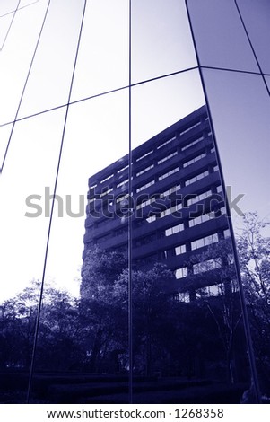Reflection of business building in window with blue color cast