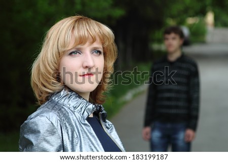 Young man is meeting girlfriend in the park.