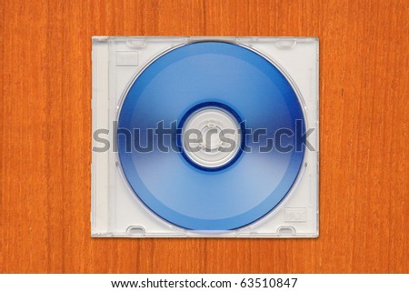 DVD-R in semi clear plastic case on wooden table.