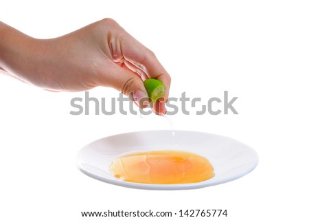Female hand squeeze a lime onto the honey