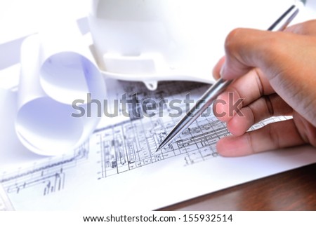 engineering plant drawing with pen in hand
