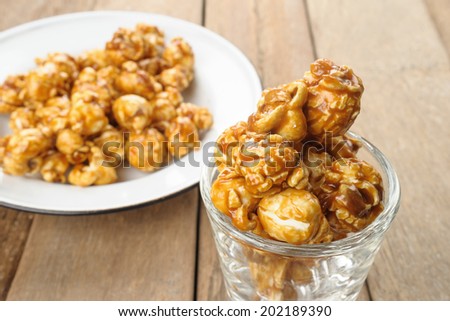 caramel popcorn isolated on wooden desk