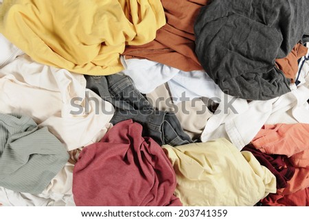 Big heap of dirty colorful clothes isolated on white background
