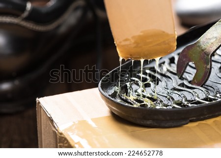 applying rubber adhesive to the shoe, shoe repair