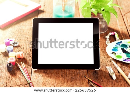 blank tablet on wooden desktop (shallow depth of field)