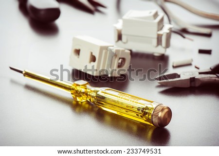 electrical tester screwdriver on technician desktop