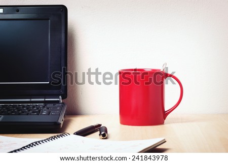 isolated red cup on wooden desk
