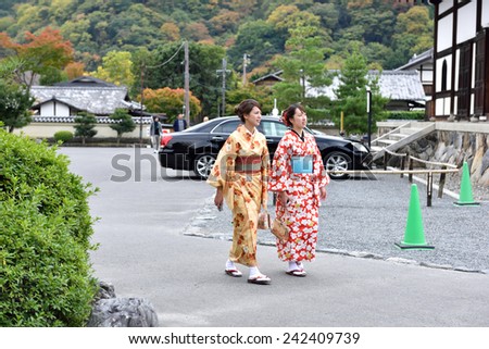 KYOTO, JAPAN - NOVEMBER 05, 2014: Unidentified japanese ladies dressed in kimono walking on street.