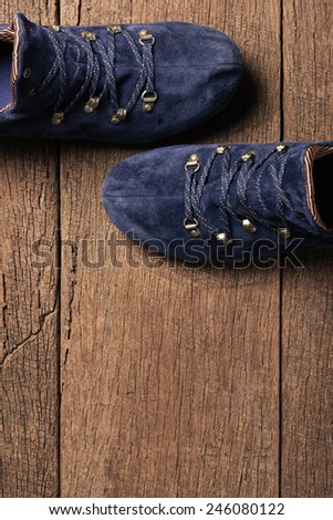 blue suede shoes on wooden plank