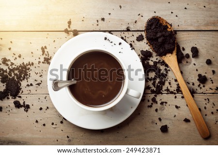 coffee cup and coffee ground on wooden table