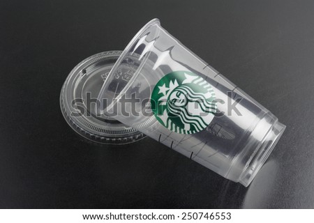 BANGKOK, THAILAND - FEBRUARY 08, 2015: Empty Starbucks coffee plastic cup on black background. Starbucks is the world\'s largest coffee house with over 20,000 stores in 61 countries.