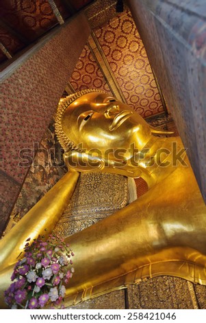 BANGKOK, THAILAND - FEBRUARY 19, 2015: Golden reclining buddha statue at Wat Pho (Wat Phra Chettuphon Wimon Mangkhlaram Ratchaworamahawihan) in Bangkok, Thailand.