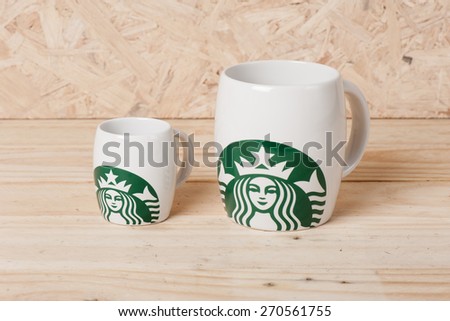 BANGKOK, THAILAND - APRIL 19, 2015: White cups with Starbucks logo. Starbucks is the world\'s largest coffee house with over 20,000 stores in 61 countries.