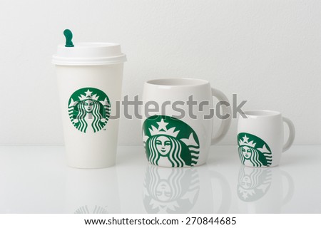 BANGKOK, THAILAND - APRIL 19, 2015: White cups with Starbucks logo. Starbucks is the world\'s largest coffee house with over 20,000 stores in 61 countries.