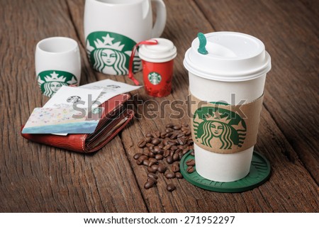 BANGKOK, THAILAND - APRIL 23, 2015: White paper cup and other gift with Starbucks logo. Starbucks is the world\'s largest coffee house with over 20,000 stores in 61 countries.