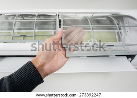 clean air conditioner filter in man\'s hand