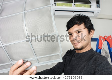 a man showing clean air filter after cleaning (focus on the filter)