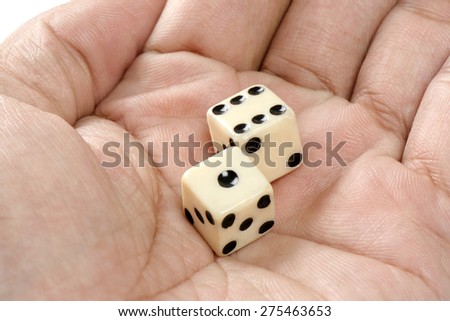 two old plastic dice isolated in hand