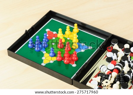 BANGKOK, THAILAND - MAY 07, 2015: Playing mini Chinese checkers in multi games in one box.