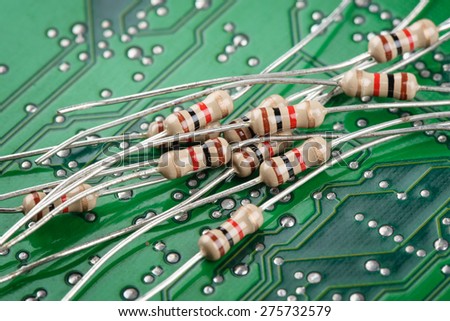closeup heap of 1K or 1000 Ohms resistors on circuit board.