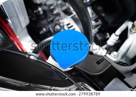 closeup blue windshield washer fluid reservoir cap in engine room