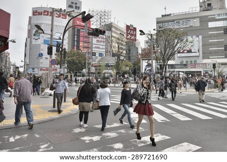 TOKYO, JAPAN - NOVEMBER 02, 2014: Many People walk in Shinjuku district of Tokyo. Tokyo is the capital city of Japan and the most populous metropolitan area in the world with almost 36 million people.
