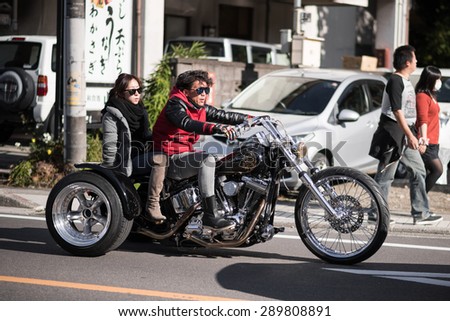 YAMANASHI, JAPAN - NOVEMBER 03, 2014: Unidentified japanese biker on a three-wheeled motorcycle.