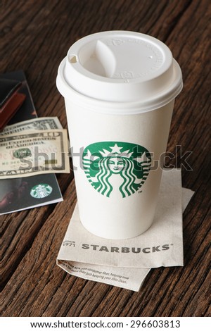 BANGKOK, THAILAND - JULY 15, 2015: White paper cup with Starbucks logo. Starbucks is the world\'s largest coffee house with over 20,000 stores in 61 countries.