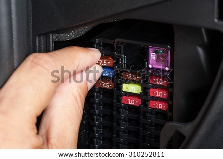 replacing the fuse in fuse box of the car