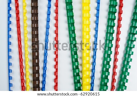 colorful plastic multi-ring paper binding spine on white background