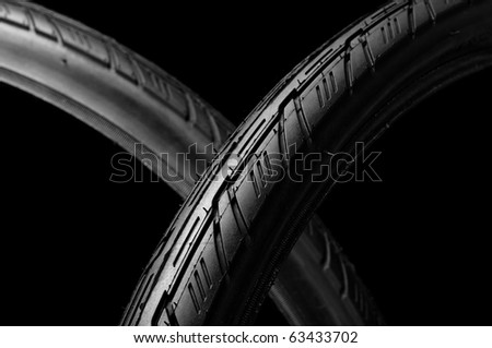 two new bicycle tires isolate on black background