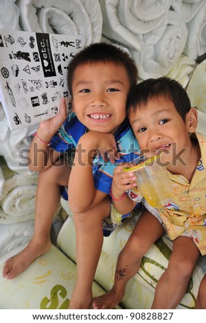 NONTHABURI, THAILAND - DECEMBER 29: A little smile from unidentified children in Temporary shelter flooding victims on December 29, 2011 in Nonthaburi, Thailand.