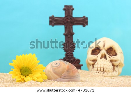 Cross and Skull with Flowers on Sand With Blue Background
