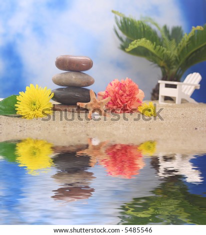 Balanced Stones and Flowers with Sea Shells on Beach With Chair and Palm Tree in Background
