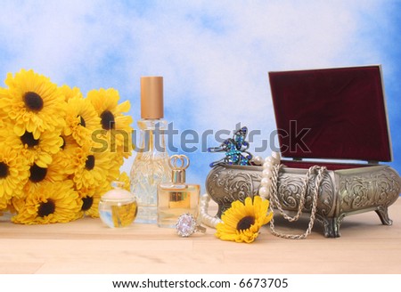 Jewelry Box With Perfume and Flowers With Blue Sky Background