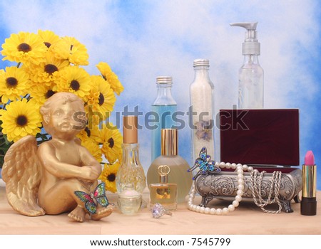 Jewelry and Perfume with Flowers and Angel on Blue and White Textured Background