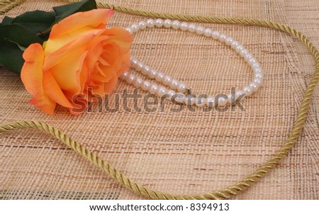 Rose on Textured Background With Pearls and Gold Rope