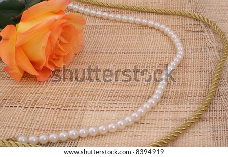 Rose on Textured Background With Pearls and Gold Rope