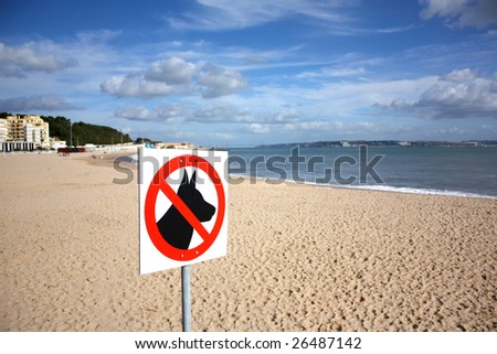 A sign on a beach meaning dogs are not allowed