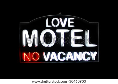Love Motel no vacancy white and red neon sign