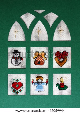 Cross stitch Christmas Card showing a snow man, an angel, a candle and a heart