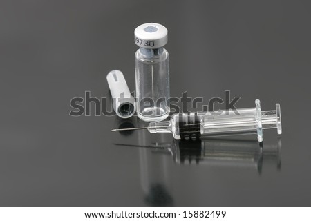 syringe needle and medical stuff on glass surface