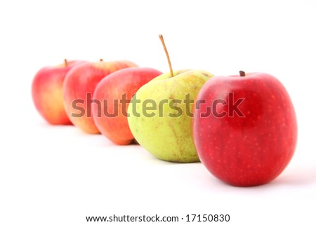 five apples on white background as a healthy food concept with focus on the green one