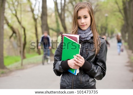 Portrait of a cool fashionable young student girl outdoors.