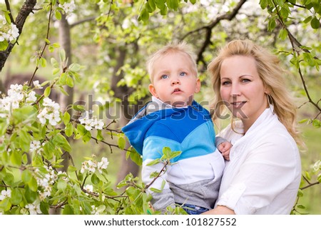 Spring family, portrait of beautiful young mother with her son outdoors.
