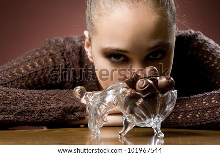 Chocolate addiction, moody portrait of gorgeous brunette with chocolate pralines.