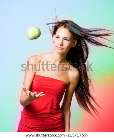 Vibrant health girl with levitating apple on rainbow background.