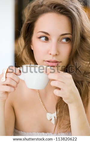 Portrait of a romantic looking hot coffee brunette lady.